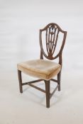 A C18th Hepplewhite period shield back chair, with pierced back and shaped overstuffed seat,
