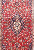 A rich red and blue ground Persian Kashan rug, of the Kashan region of Iran, 78" x 39"
