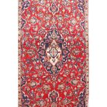 A rich red and blue ground Persian Kashan rug, of the Kashan region of Iran, 78" x 39"