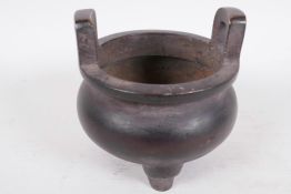 A Chinese bronze two handled cauldron shaped censer, 4" diameter