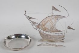 A silver filigree model of a sailing ship, 6½" long, and a small silver pin tray with engine