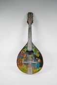 A Russian made flat back mandolin, the body painted with a figure and bird in a tree, signed