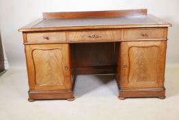 A good quality Swedish mahogany twin pedestal desk with inset leather writing surface over three