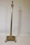 A Corinthian column standard lamp with stepped platform base and paw feet, 53" high