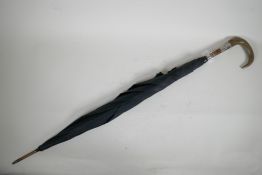 An antique horn handled umbrella with engraved silver mount, 35" long