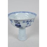 A Chinese blue and white porcelain stem bowl with embossed dragon decoration to the interior, the