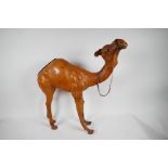 A goatskin figure of a camel with glass eyes, 19" high