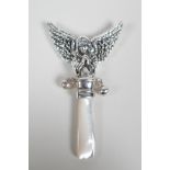 A sterling silver baby's rattle with angelic decoration and a mother of pearl style handle, 3½" long