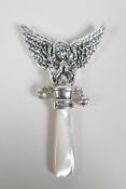 A sterling silver baby's rattle with angelic decoration and a mother of pearl style handle, 3½" long