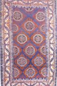 A blue ground Middle Eastern wool rug with a Bokhara style design, 41" x 72"