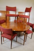 A mid century rosewood extending dining table and six chairs by C.J. Rosengaarden, with two