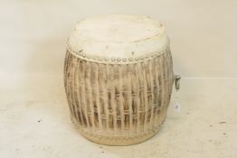 A carved and distressed hardwood drum converted to an occasional table, 19" high x 18" diameter