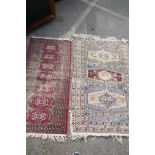 A blue ground Eastern tribal rug with three stylised medallions within three borders, 57" x 35" (