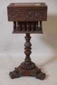 An Anglo-Indian padauk wood workbox, with carved decoration and galleried well, raised on a carved