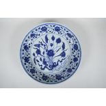 A Chinese Ming style blue and white porcelain dish with scrolling lotus flower decoration, 6