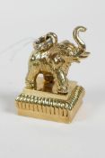 A brass document seal with an elephant shaped handle/mount, 2" high