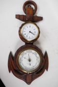 A nautical themed aneroid barometer and clock mounted in a carved oak rope and anchor frame, 21"