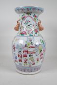 A Chinese famille rose porcelain two handled vase, with enamelled decorative panels depicting and