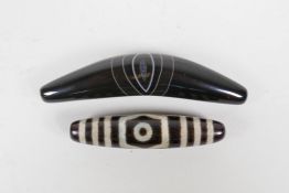 A Tibetan dzi bead and another lozenge shaped banded agate bead, 3" longest