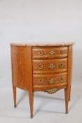 A Louis XV style demi-lune three drawer commode, with inset burr walnut inlaid panels, brass handles