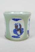 A Chinese celadon glazed porcelain brush pot with blue, white and red decorative panels depicting