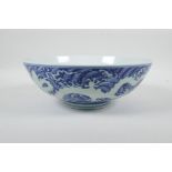 A Chinese blue and white porcelain bowl with twin dragon decoration, 6 character mark to base, 10"