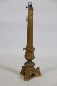 An antique gilt brass table lamp with fluted column and scroll supports, 22" high