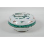A Chinese famille verte porcelain circular box and cover decorated with a dragon and flaming