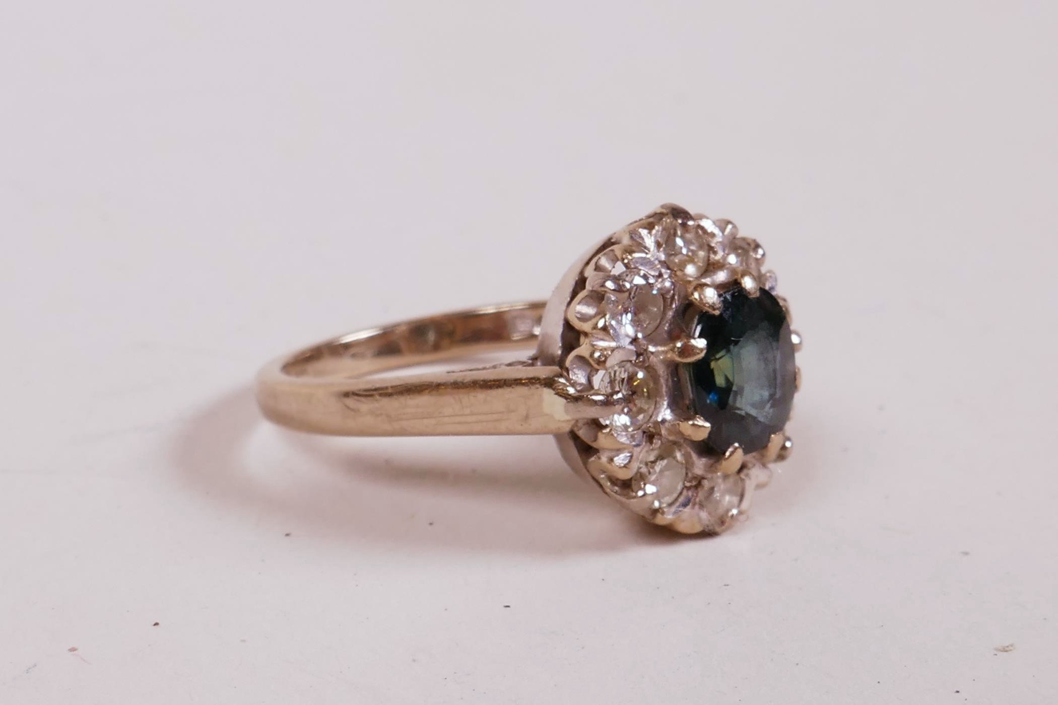 An 18ct white gold dress ring, set with a sapphire and eight diamonds, sapphire approximately 1ct, - Image 3 of 4