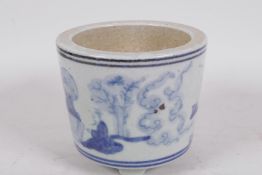 A squat Chinese blue and white porcelain cylindrical vase on three feet decorated with figures in