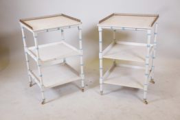 A pair of painted three tier side tables, raised on ring turned supports with brass castors and