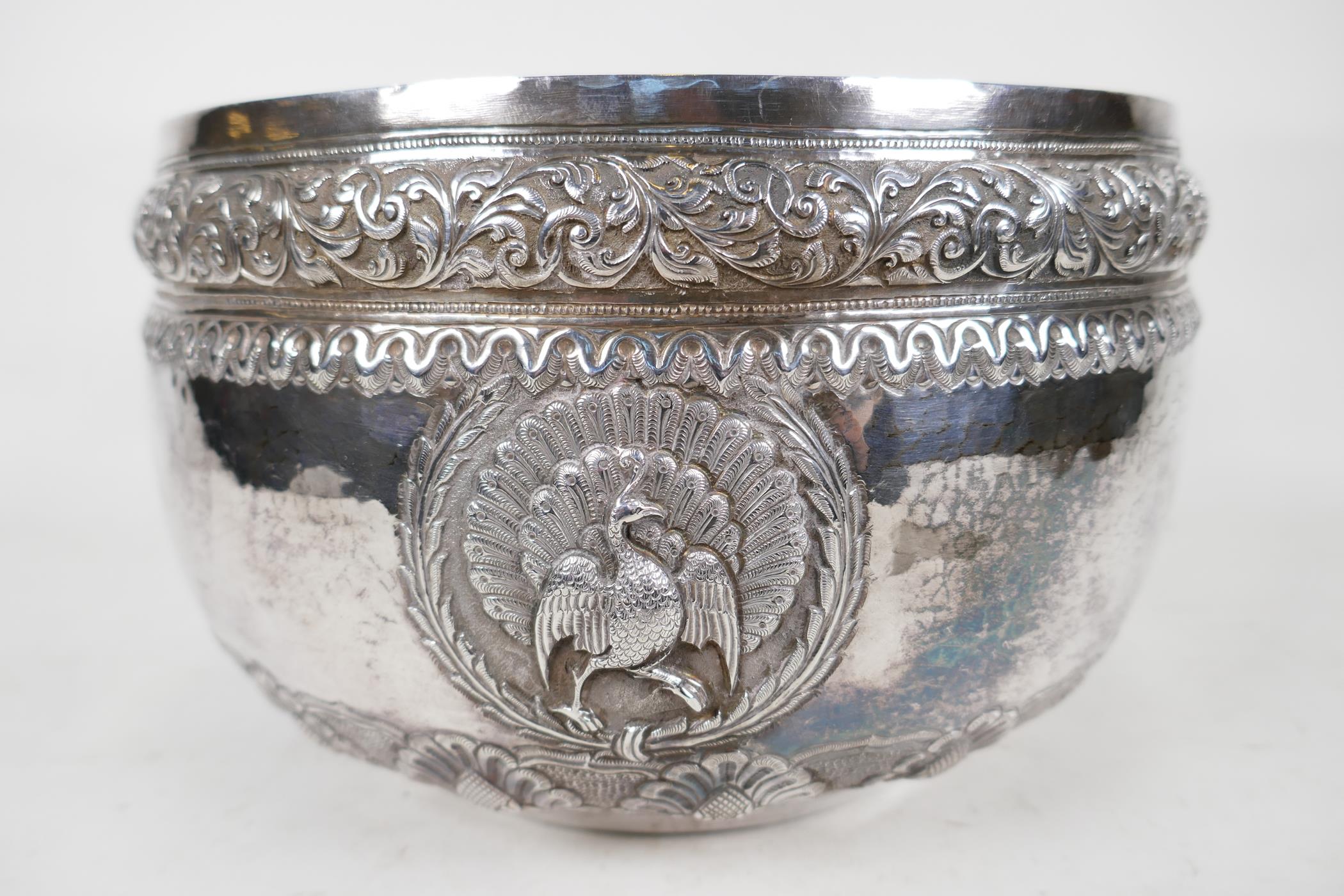 An antique Indian silver bowl, hammered silver with embossed scrolling decoration, a bas relief - Image 3 of 8