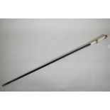 A Victorian dandy's cane with ebonised shaft and bone handle with pinchbeck mounts, 33" long