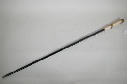 A Victorian dandy's cane with ebonised shaft and bone handle with pinchbeck mounts, 33" long