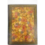 A Kashmiri papier mache book cover profusely decorated with flowers, 9" x 12"