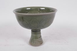 A Chinese dark green jade celadon stem cup decorated with dragons and fish, 5" high