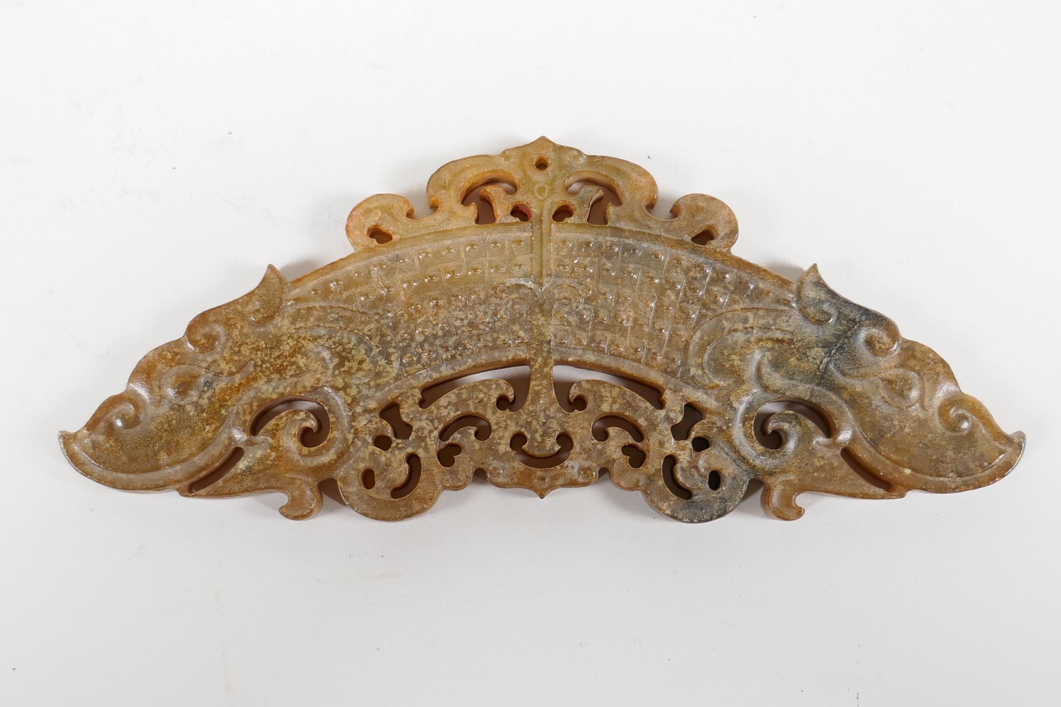 A Chinese carved and pierced hardstone ornament/pendant with stylised dragon decoration, 5½" long