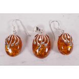 A silver and faux amber suite of earrings and pendant drop (3)