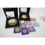 A collection of commemorative coins to include crowns, shillings, and oversized 24ct gold plated '