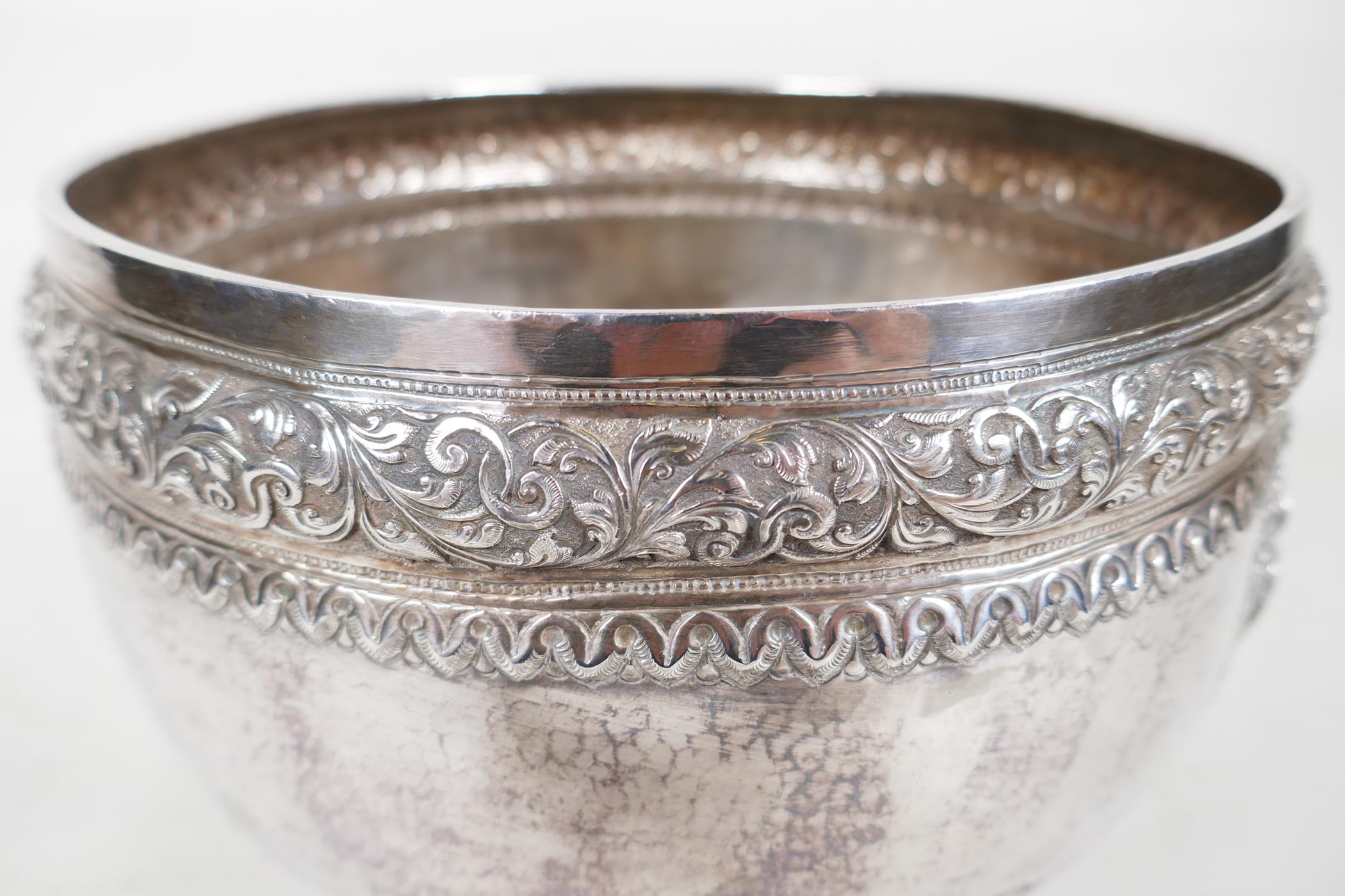 An antique Indian silver bowl, hammered silver with embossed scrolling decoration, a bas relief - Image 4 of 8