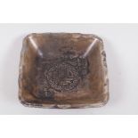 A Chinese white metal pin tray embossed with figures, symbols and calligraphy, 3" square