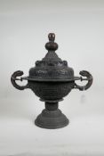 A Chinese bronze censer with dragon handles and archaic style raised decoration, and pierced