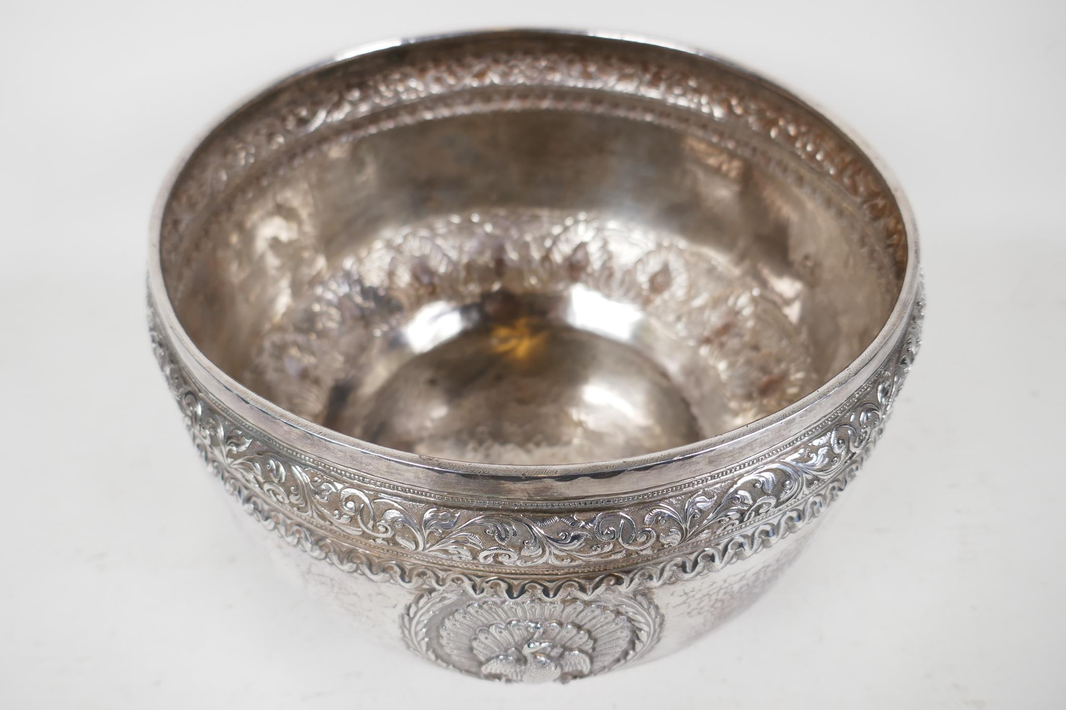 An antique Indian silver bowl, hammered silver with embossed scrolling decoration, a bas relief - Image 2 of 8