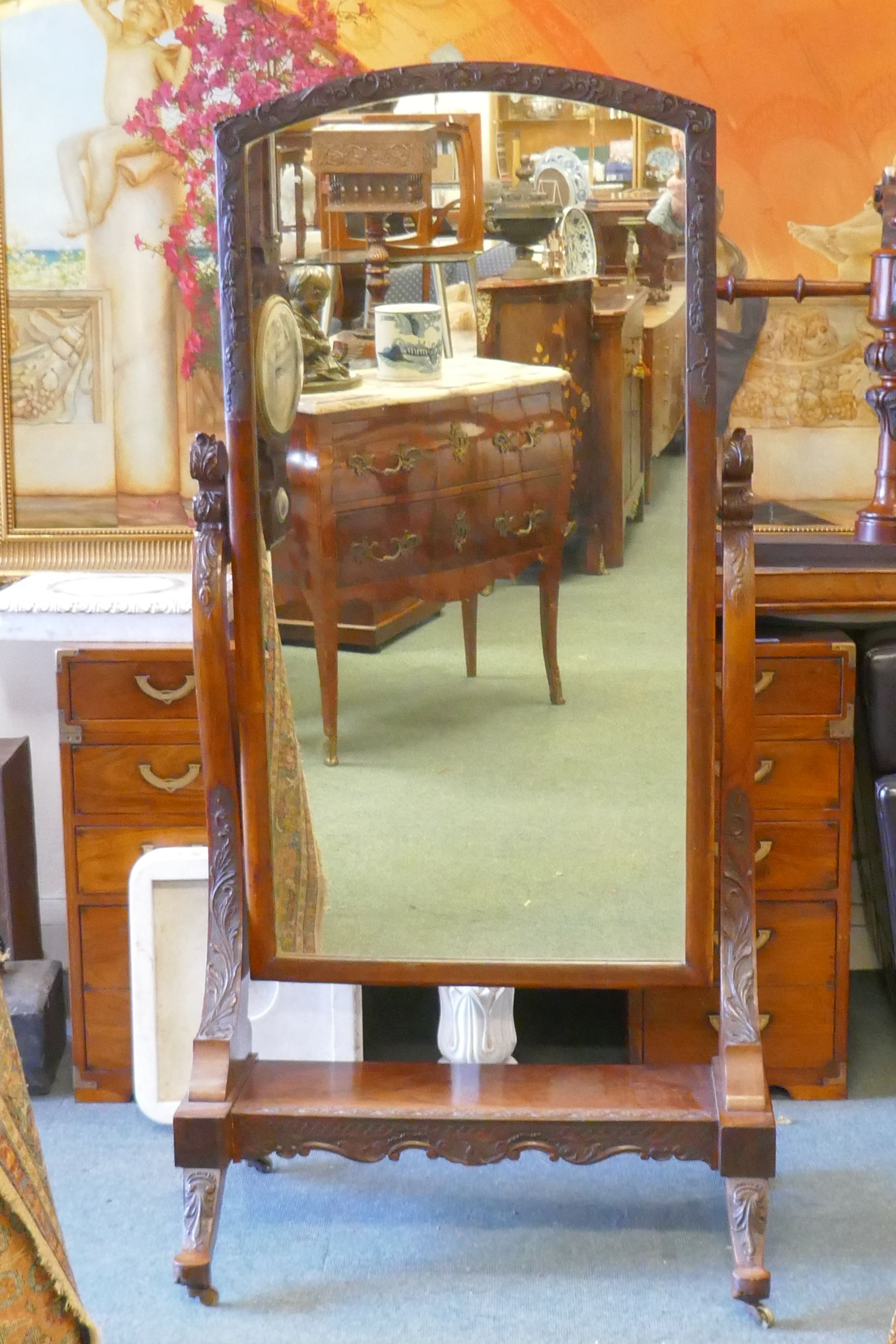 A C19th walnut cheval mirror with carved frame