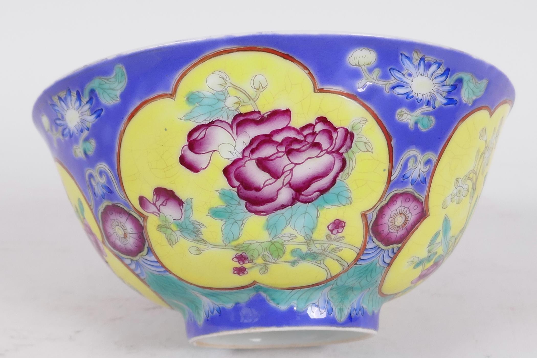 A Chinese porcelain bowl with blue ground and yellow panels painted with flowers, red seal mark to - Image 2 of 3