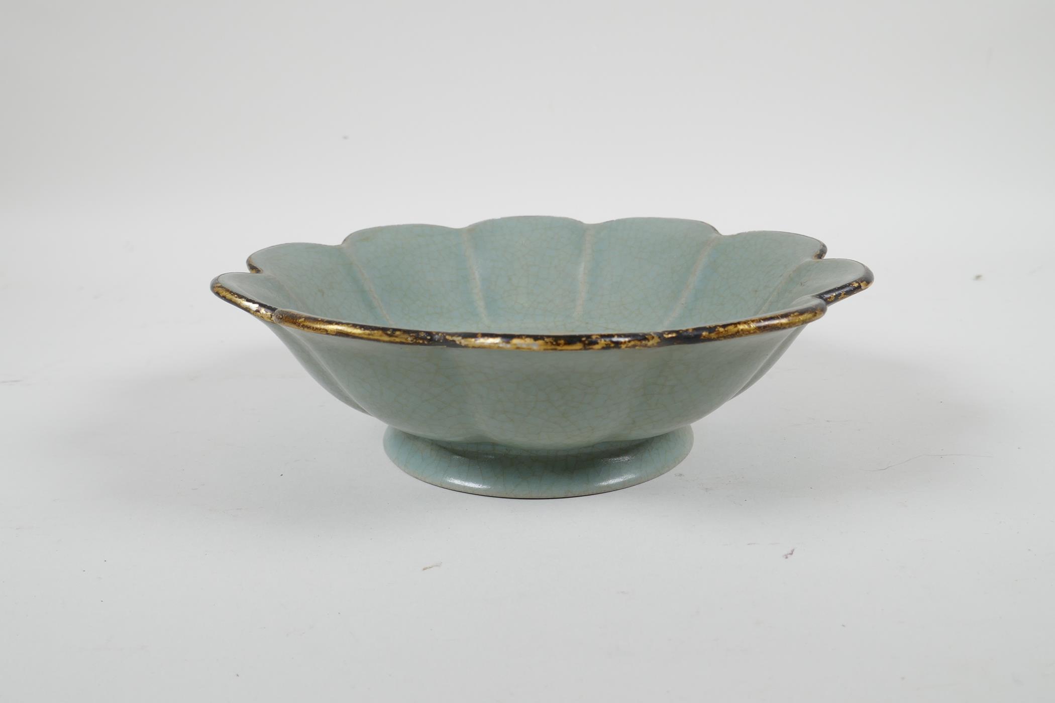 A Chinese Song style celadon crackle glazed bowl of petal form, with a gilt rim, the bowl with
