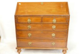 A C19th walnut fall front bureau with fitted interior and two over three drawers with pressed