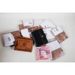 A collection of wallets including novelty UK £50 note and US $100 bills