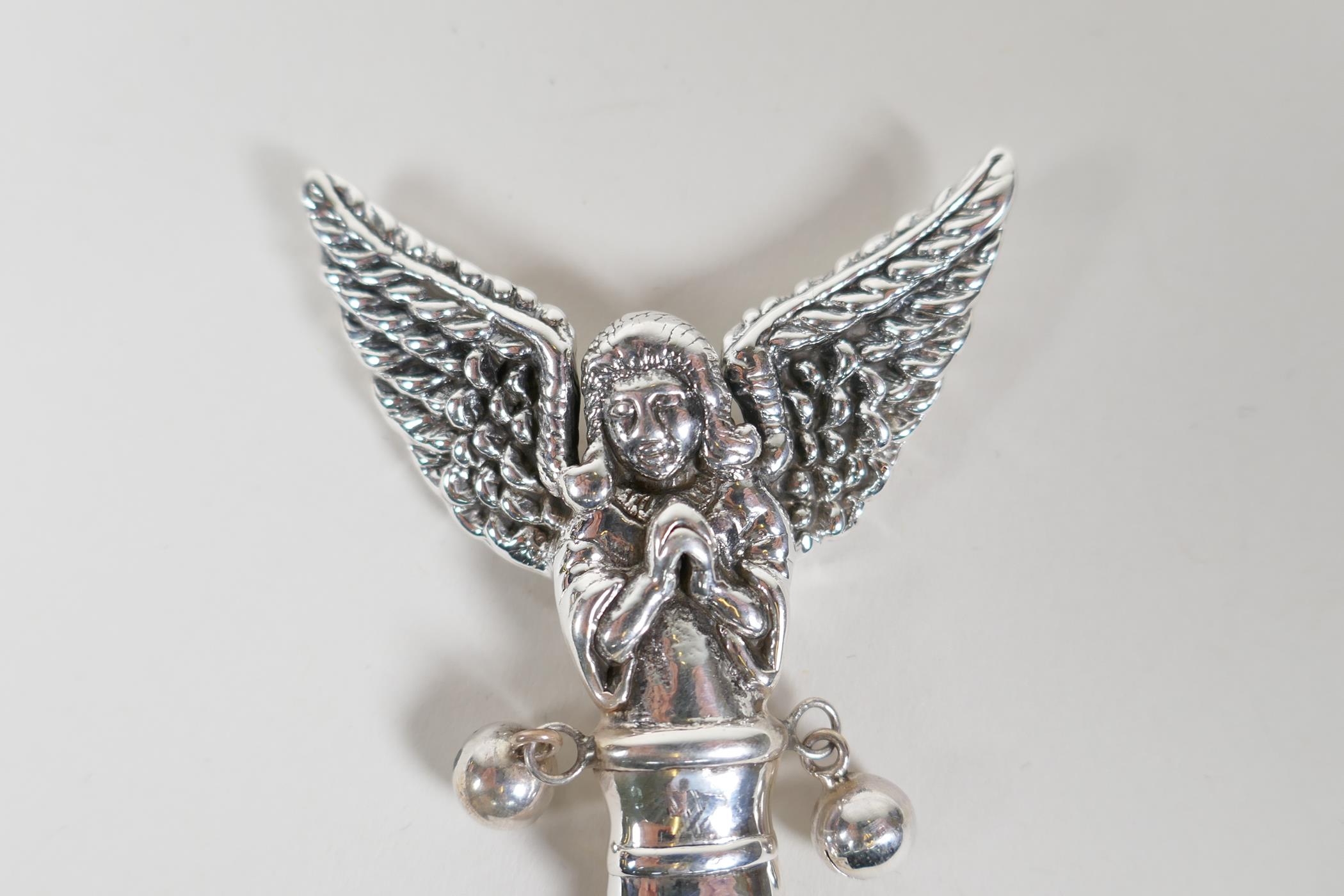 A sterling silver baby's rattle with angelic decoration and a mother of pearl style handle, 3½" long - Image 2 of 2