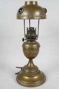 A brass table lamp with brass shade set with coloured stones, 13" high
